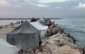 يقضي الفلسطينيون النازحون وقتهم على الشاطئ مقابل خيامهم الممتدة على طول ميناء غزة في مدينة غزة